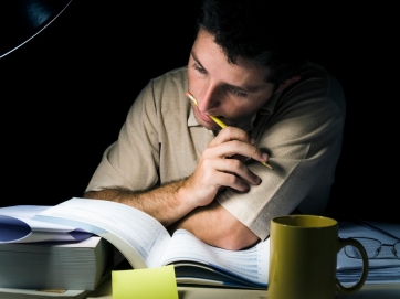 Young Man Studying at Night
